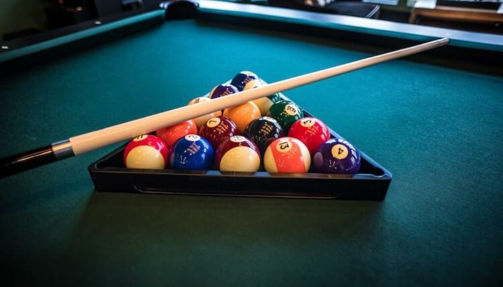 pool cue on rack of pool balls