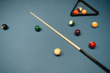 pool cue and pool balls on a table