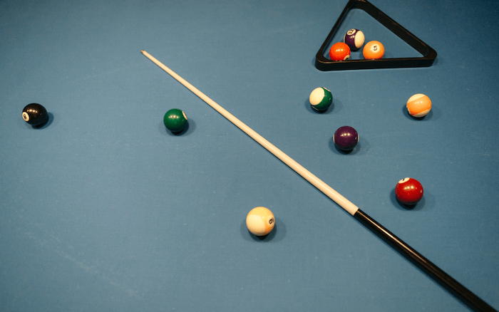 pool cue and pool balls on a table