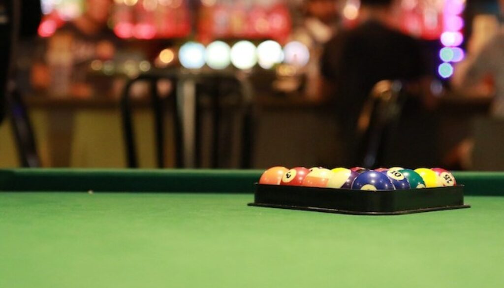 racked pool balls on pool table at a bar