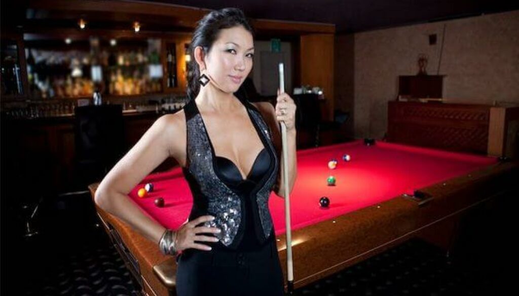 Jeanette Lee standing next to pool table