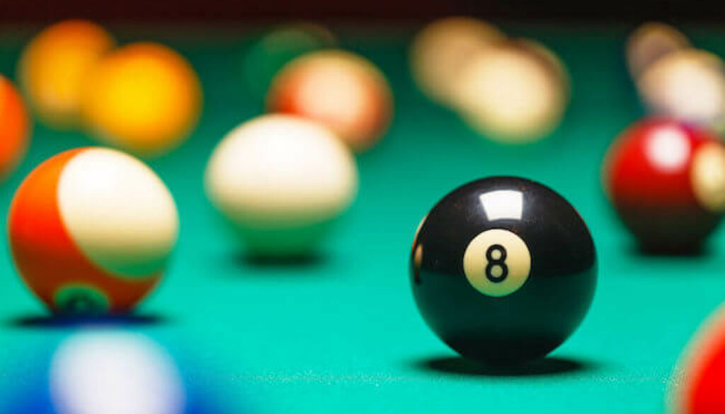 pool balls scattered on pool table